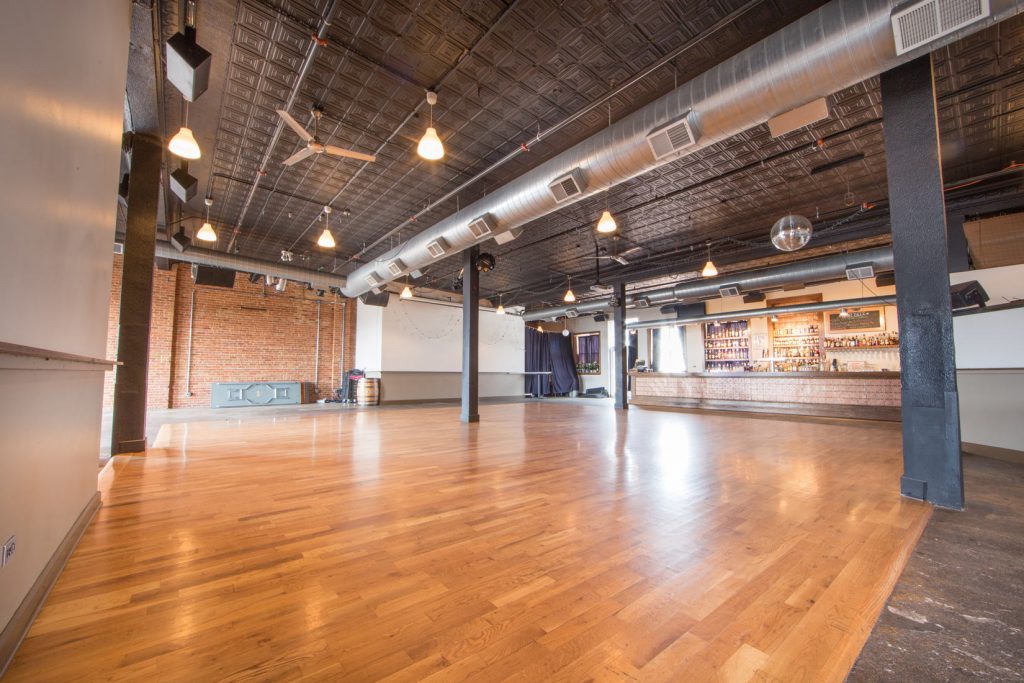 The empty upstairs warehouse-loft space at Bottom Lounge, with hardwood floors and exposed ceiling